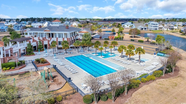 view of swimming pool featuring fence and a residential view