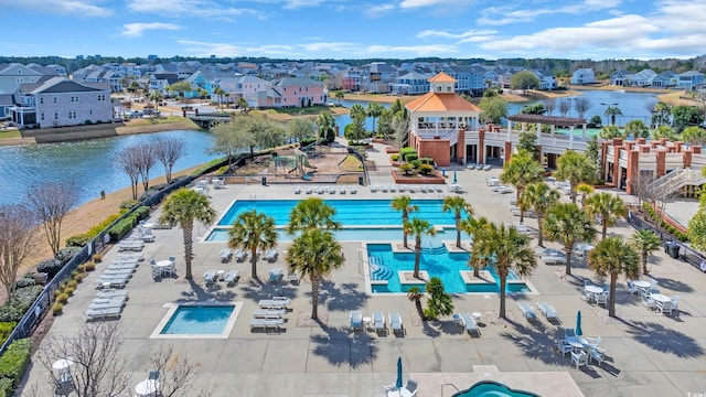 birds eye view of property featuring a water view and a residential view