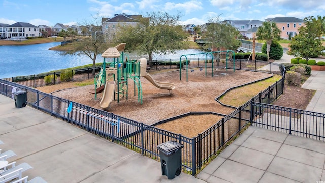 community playground with a water view, fence, and a residential view