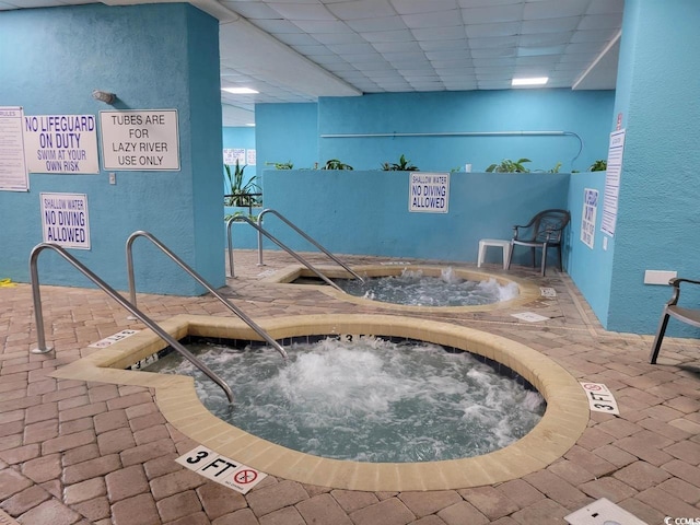 view of swimming pool with an indoor in ground hot tub