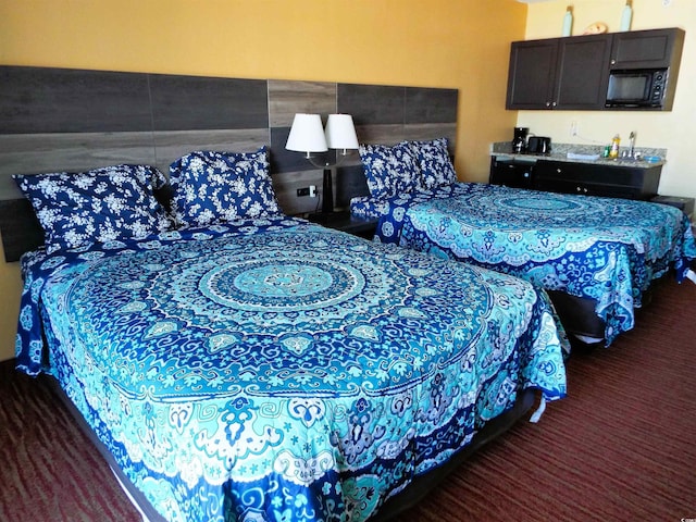 carpeted bedroom featuring indoor bar