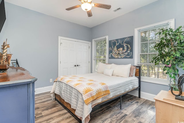 bedroom featuring visible vents, baseboards, and multiple windows