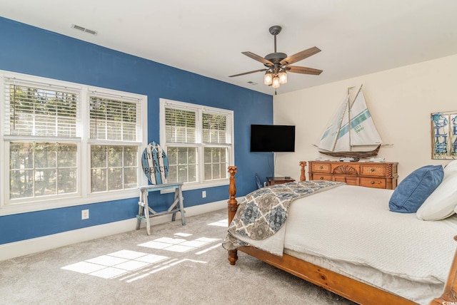 carpeted bedroom featuring visible vents, baseboards, and ceiling fan
