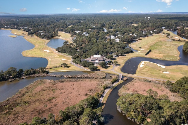 drone / aerial view with a water view, golf course view, and a wooded view