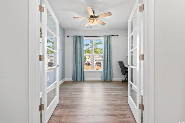 doorway with visible vents, wood finished floors, baseboards, french doors, and a ceiling fan