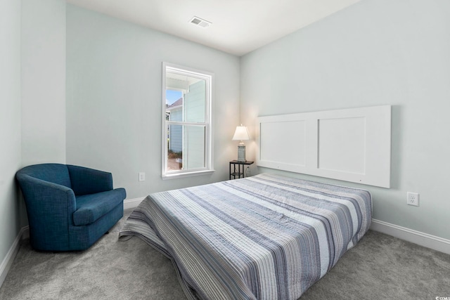 carpeted bedroom featuring baseboards and visible vents