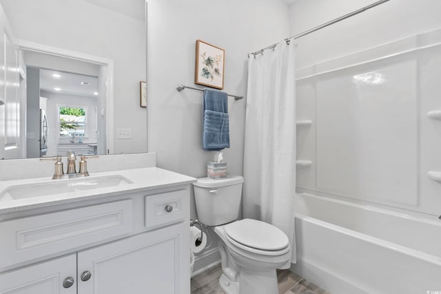 bathroom featuring vanity, shower / bath combo, toilet, and wood finished floors