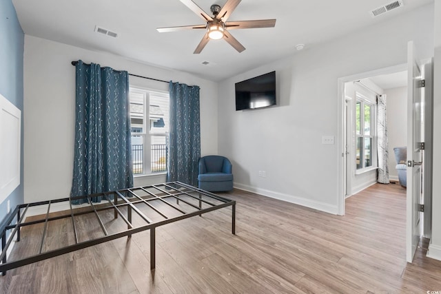 unfurnished room with baseboards, visible vents, and wood finished floors