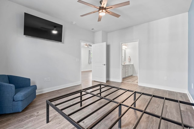 bedroom with visible vents, baseboards, and wood finished floors