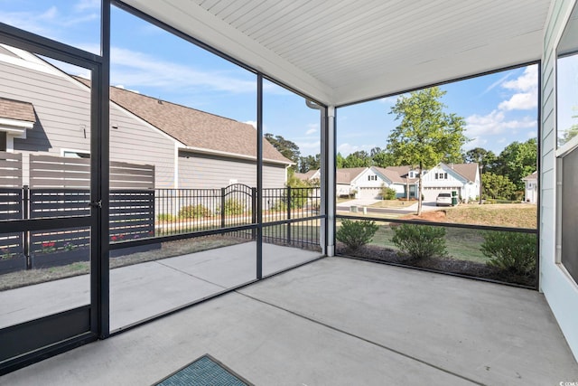 unfurnished sunroom featuring a residential view