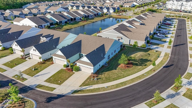 birds eye view of property featuring a water view and a residential view