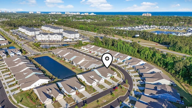 drone / aerial view with a residential view and a water view