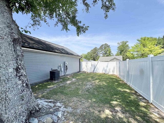 view of yard with a fenced backyard and central air condition unit