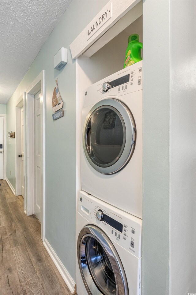 204 Maison Dr Unit N304, Myrtle Beach, SC 29572 - laundry room featuring stacked washer / drying machine, wood finished floors, and a textured ceiling