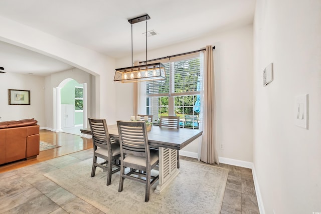 140 Zinnia Dr, Myrtle Beach, SC 29579 - dining area featuring arched walkways, baseboards, a chandelier, and visible vents