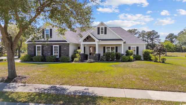 1028 Whooping Crane Dr, Conway, SC 29526 - view of front of house featuring a front lawn, board and batten siding, stone siding, and covered porch