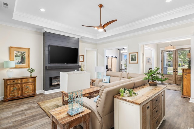 1028 Whooping Crane Dr, Conway, SC 29526 - living room with wood finished floors, ceiling fan, a raised ceiling, recessed lighting, and a fireplace