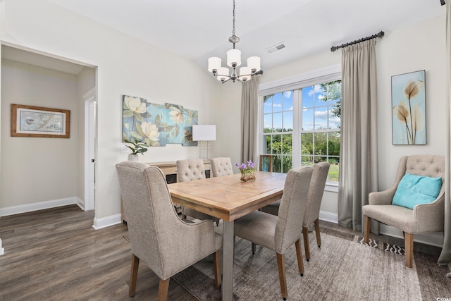 dining space featuring visible vents, dark wood-style flooring, lofted ceiling, baseboards, and a notable chandelier