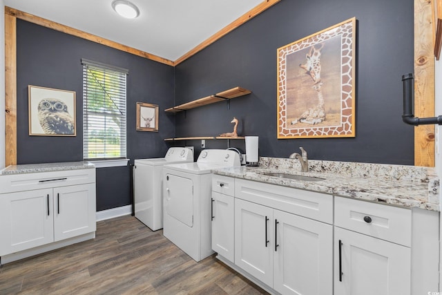 clothes washing area featuring separate washer and dryer, a sink, cabinet space, and dark wood-style flooring