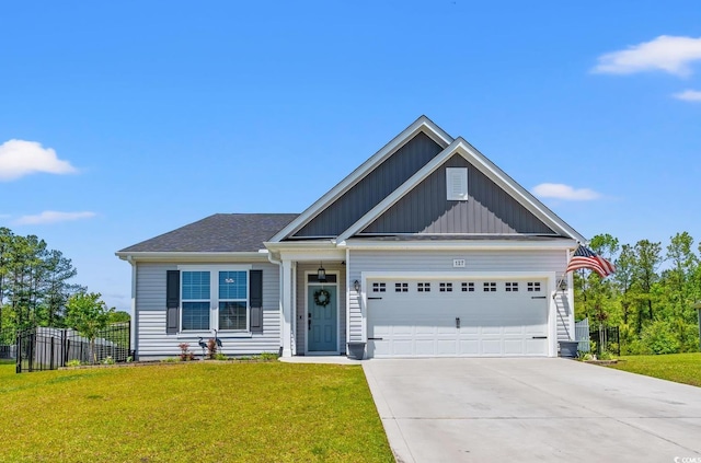 craftsman-style house featuring fence, an attached garage, a front lawn, board and batten siding, and driveway