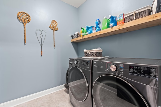 laundry room featuring baseboards, laundry area, and washer and clothes dryer