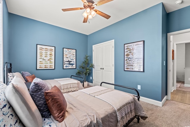 bedroom featuring baseboards, carpet floors, a closet, and ceiling fan
