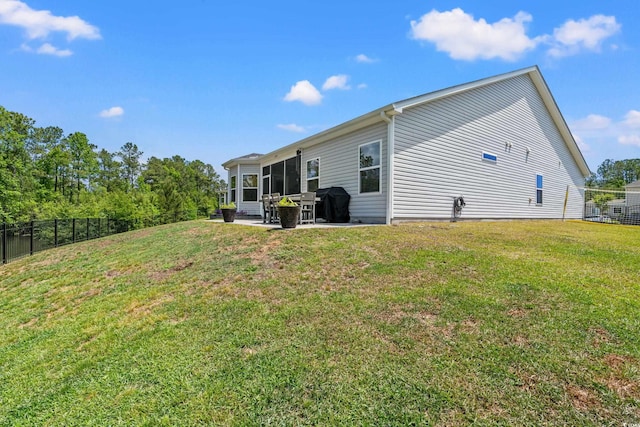back of house with fence, a lawn, and a patio area
