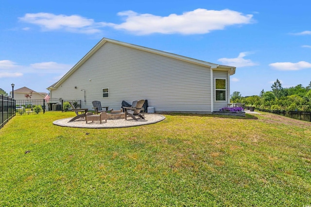 back of property featuring a fenced backyard, a lawn, an outdoor fire pit, and a patio area