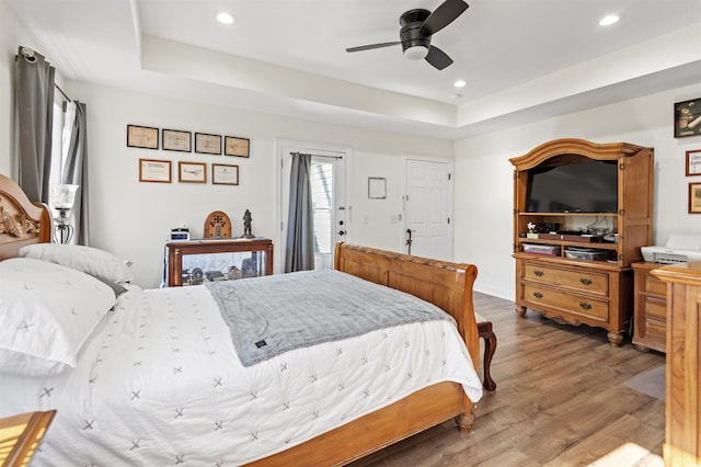 113 Edwards Ln, Longs, SC 29568 - bedroom with wood finished floors, recessed lighting, a tray ceiling, and a ceiling fan