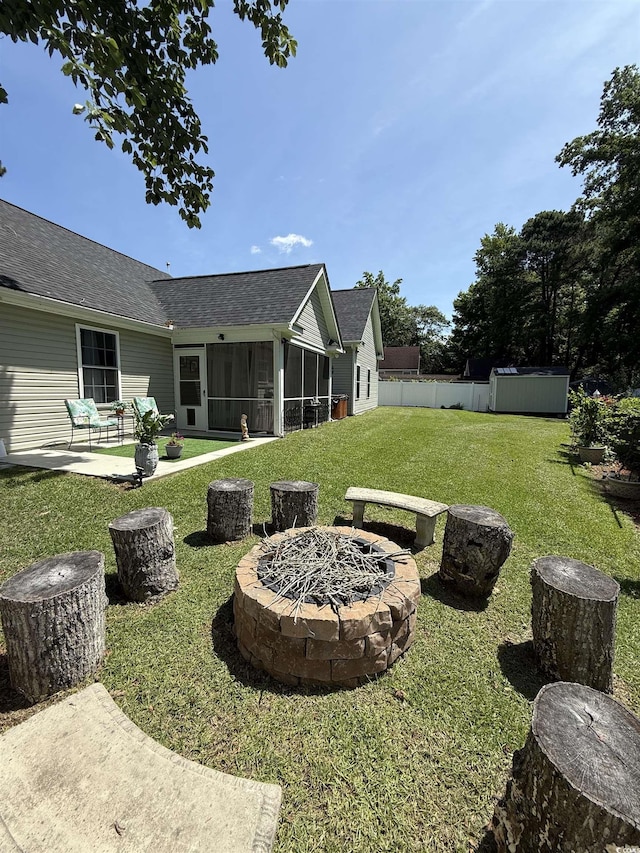 113 Edwards Ln, Longs, SC 29568 - view of grassy yard with a fire pit, a sunroom, a patio, and a storage shed