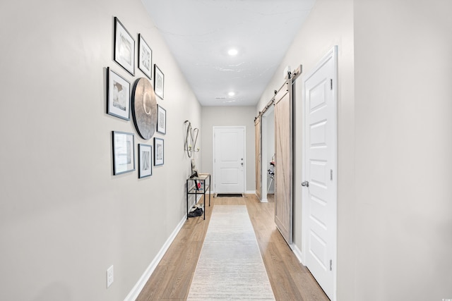 1015 Saltgrass Way, Myrtle Beach, SC 29588 - corridor featuring a barn door, light wood-type flooring, baseboards, and recessed lighting