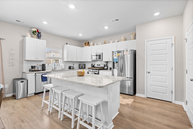 1015 Saltgrass Way, Myrtle Beach, SC 29588 - kitchen featuring a sink, stainless steel appliances, a breakfast bar area, visible vents, and a center island