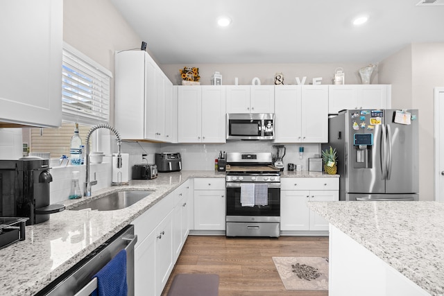 1015 Saltgrass Way, Myrtle Beach, SC 29588 - kitchen featuring white cabinets, appliances with stainless steel finishes, and a sink