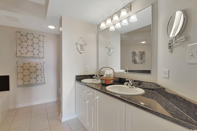bathroom with visible vents, a sink, tile patterned floors, and double vanity