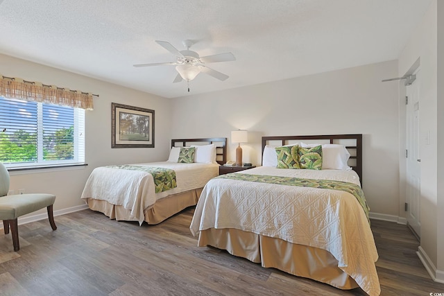 bedroom featuring baseboards, ceiling fan, and wood finished floors