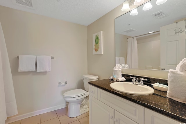 bathroom featuring vanity, tile patterned flooring, toilet, and visible vents