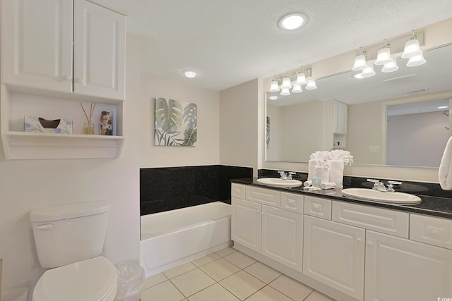bathroom with toilet, a textured ceiling, a bath, tile patterned floors, and a sink