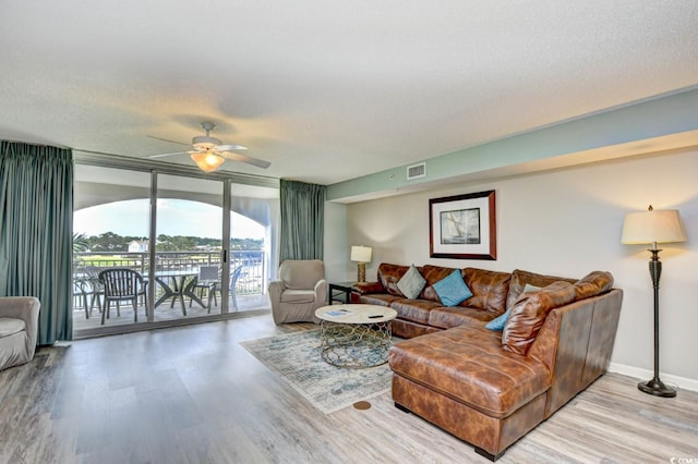 2151 Bridge View Ct Unit 2302, North Myrtle Beach, SC 29582 - living area with wood finished floors, ceiling fan, expansive windows, and a textured ceiling