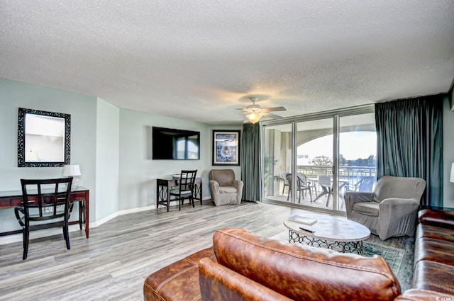 2151 Bridge View Ct Unit 2302, North Myrtle Beach, SC 29582 - living area featuring a textured ceiling, light wood finished floors, and a ceiling fan