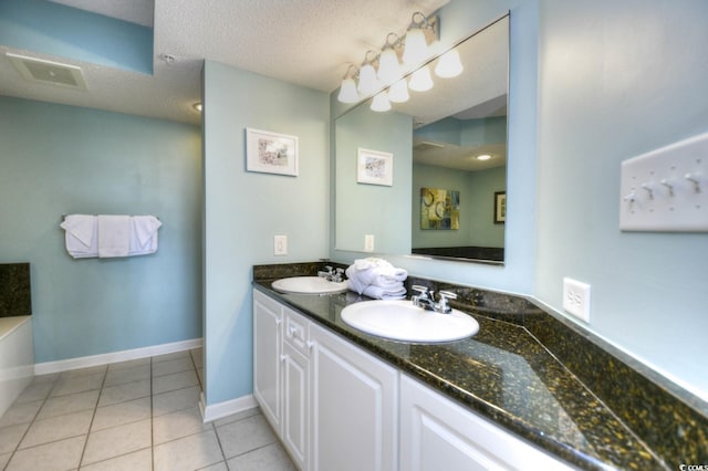 2151 Bridge View Ct Unit 2302, North Myrtle Beach, SC 29582 - full bathroom with double vanity, tile patterned floors, a bathtub, and a textured ceiling