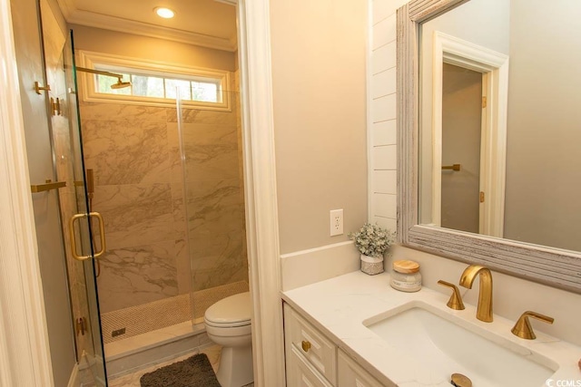 bathroom with crown molding, toilet, a shower stall, and vanity