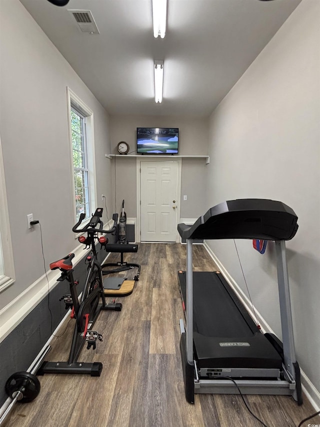 workout room featuring visible vents and wood finished floors