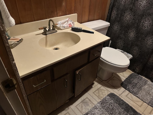 bathroom featuring toilet, tile patterned floors, and vanity