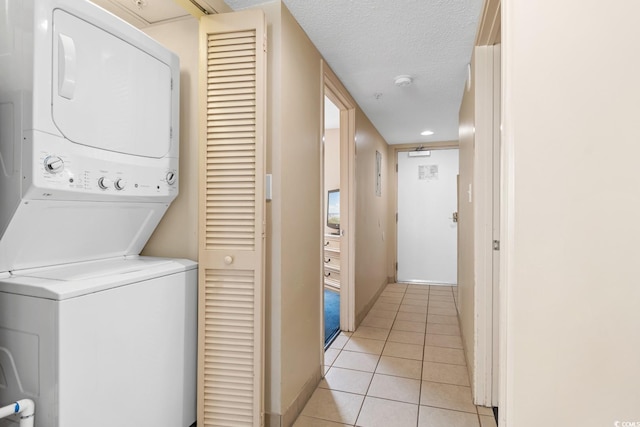 2000 N Ocean Blvd Unit 301, Myrtle Beach, SC 29577 - laundry area with stacked washer / dryer, light tile patterned floors, baseboards, a textured ceiling, and recessed lighting