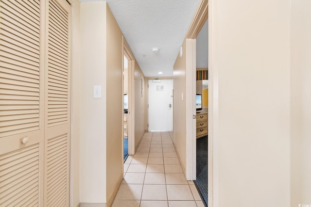 2000 N Ocean Blvd Unit 301, Myrtle Beach, SC 29577 - hallway with light tile patterned floors, a textured ceiling, baseboards, and recessed lighting