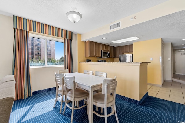 2000 N Ocean Blvd Unit 301, Myrtle Beach, SC 29577 - dining area featuring a textured ceiling, baseboards, light tile patterned floors, and recessed lighting