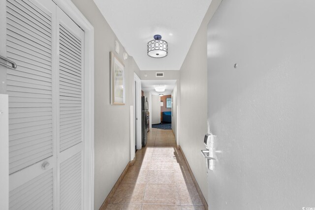5200 N Ocean Blvd Unit 833, Myrtle Beach, SC 29577 - hall featuring baseboards, visible vents, and light tile patterned floors
