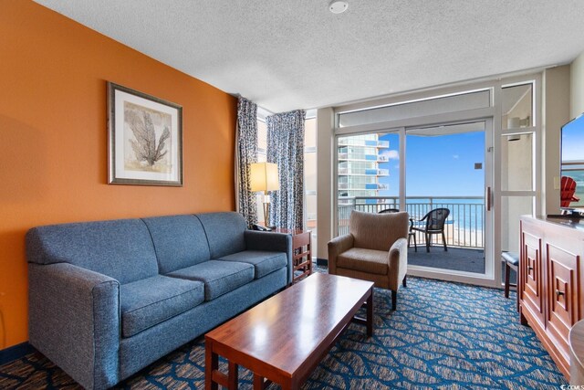 5200 N Ocean Blvd Unit 833, Myrtle Beach, SC 29577 - living area featuring a textured ceiling and a wall of windows