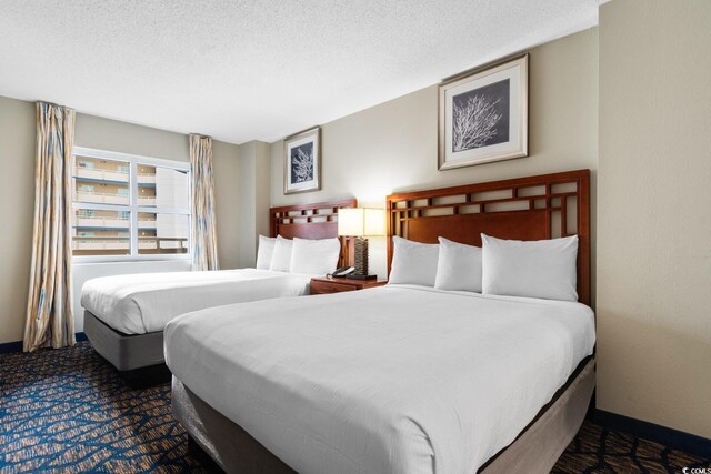 5200 N Ocean Blvd Unit 833, Myrtle Beach, SC 29577 - bedroom featuring carpet floors and a textured ceiling