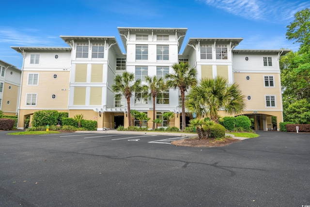 view of building exterior featuring uncovered parking
